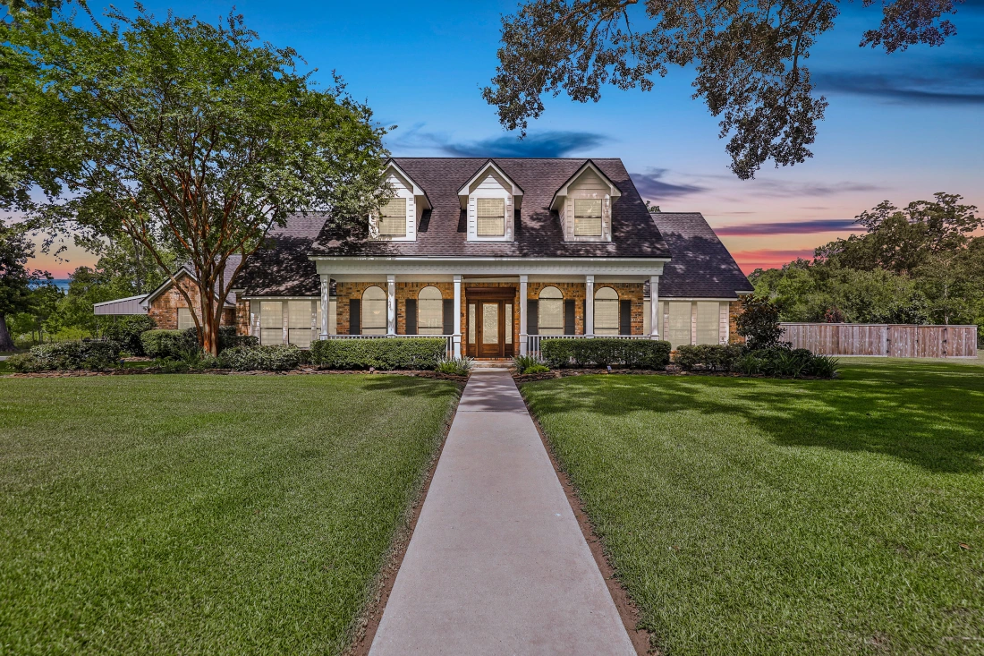 A large house with a long driveway in front of it.